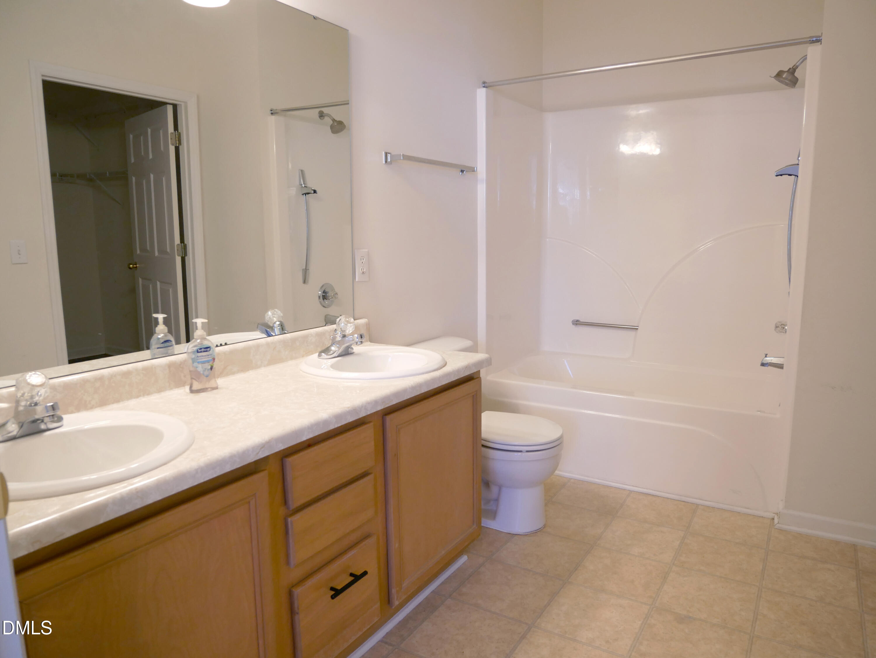 4400 Cottage Stone Drive Raleigh, NC 27616 - Photo 12 of 19 a bathroom with a granite countertop sink toilet a large mirror a bathtub and shower