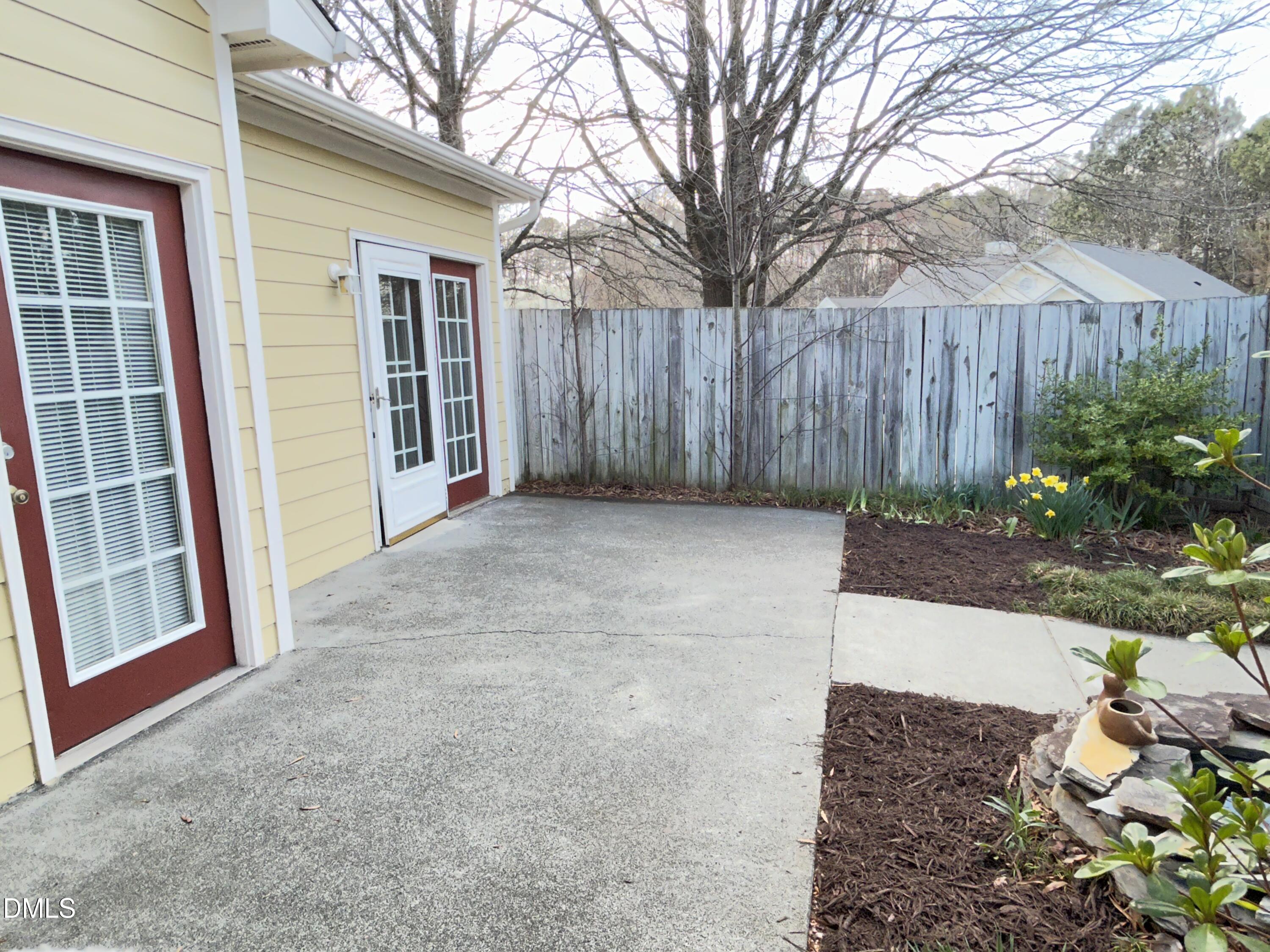 4400 Cottage Stone Drive Raleigh, NC 27616 - Photo 18 of 19 a view of a backyard with large trees and wooden fence