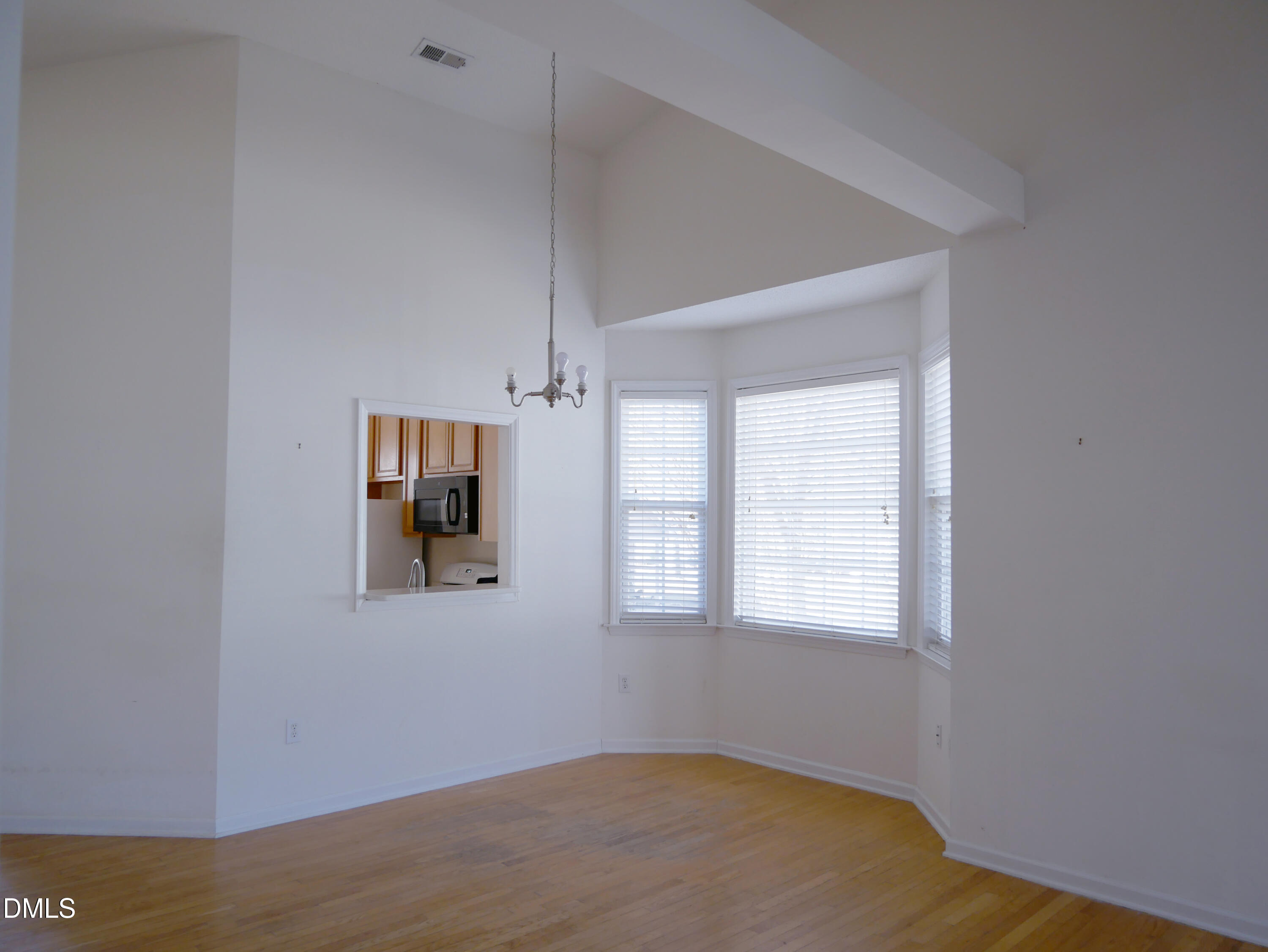 4400 Cottage Stone Drive Raleigh, NC 27616 - Photo 3 of 19 a view of an empty room with wooden floor and a window