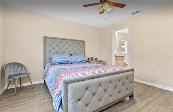 a bedroom with a bed a dresser and chair