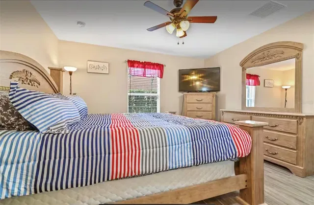 a bedroom with furniture and a flat screen tv