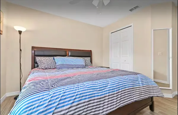 a bedroom with a bed and wooden floor