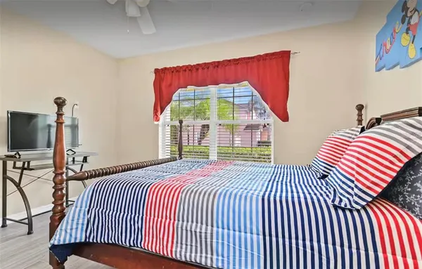 a bedroom with a bed and a flat screen tv