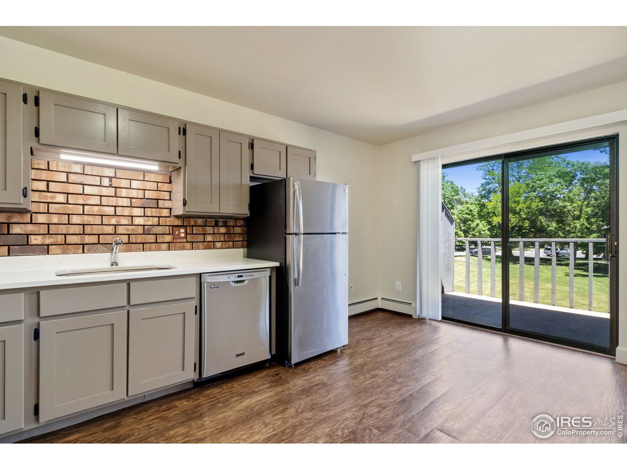 705 East Drake Road, Unit M 46 Fort Collins, CO 80525 - Photo 11 of 27 a kitchen with stainless steel appliances granite countertop a refrigerator a sink a stove a microwave and wooden cabinets