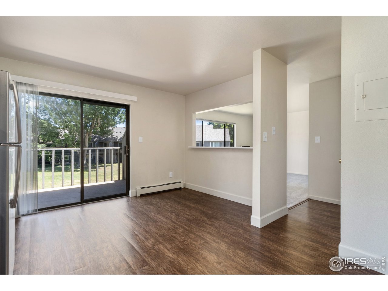 705 East Drake Road, Unit M 46 Fort Collins, CO 80525 - Photo 12 of 27 an empty room with wooden floor and windows