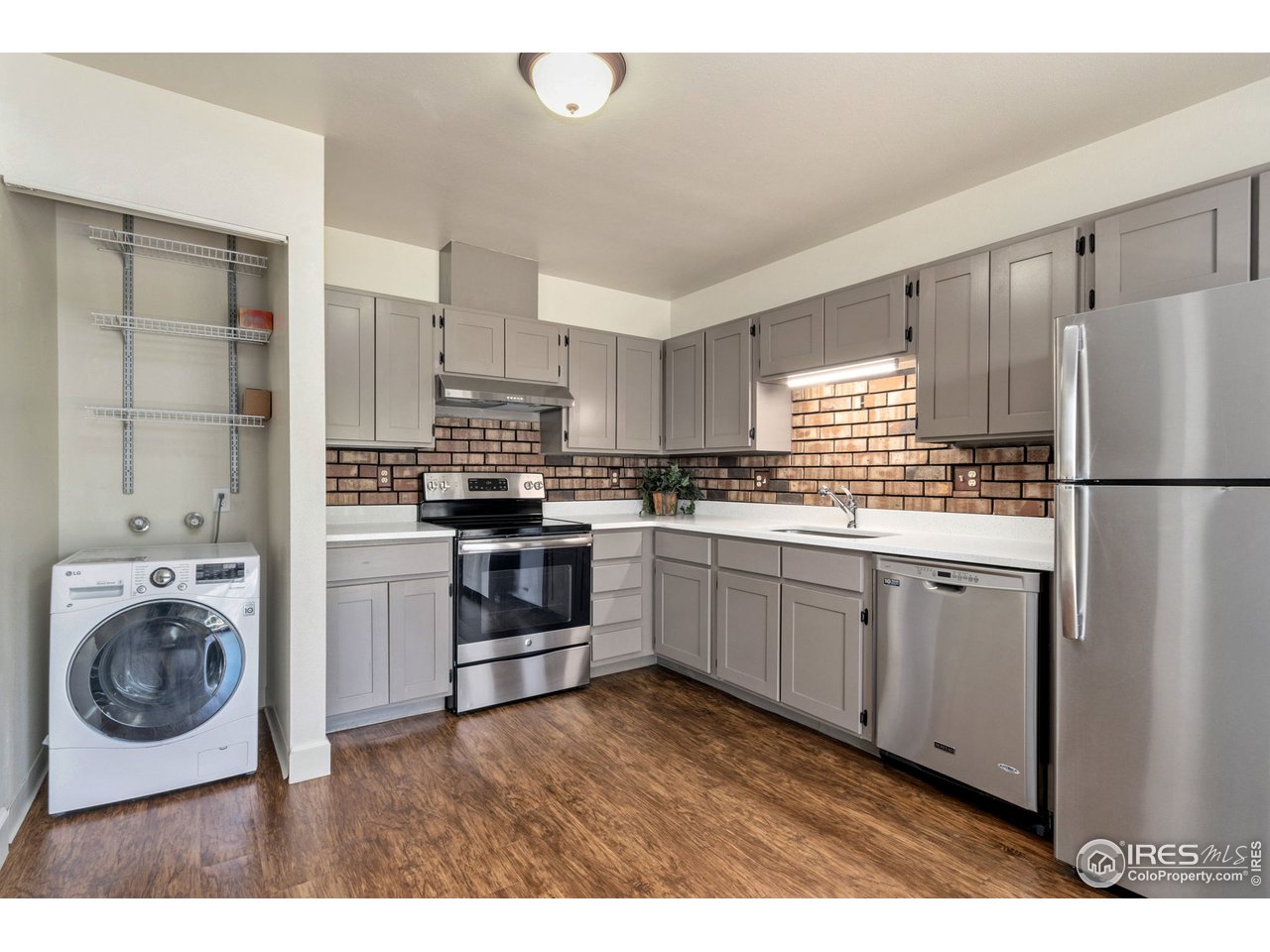 705 East Drake Road, Unit M 46 Fort Collins, CO 80525 - Photo 13 of 27 a kitchen with a refrigerator sink and cabinets