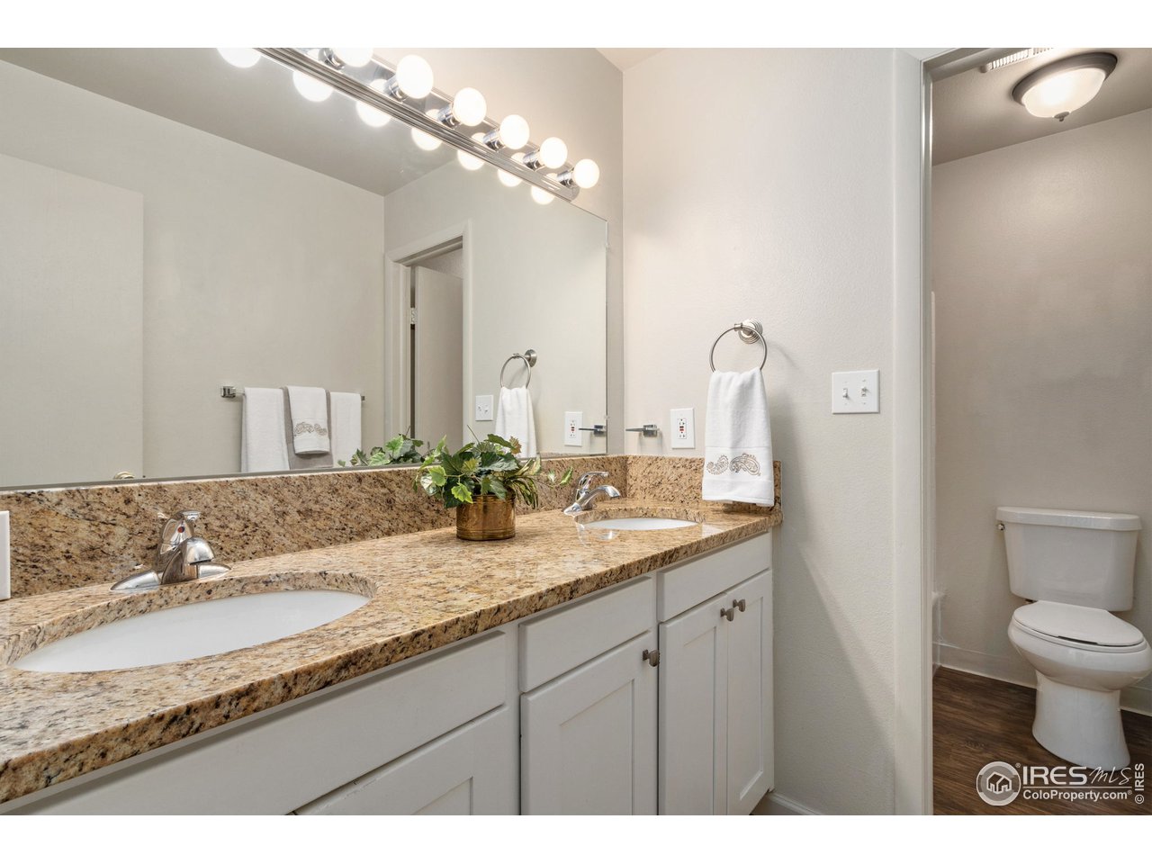 705 East Drake Road, Unit M 46 Fort Collins, CO 80525 - Photo 16 of 27 a bathroom with a granite countertop sink a toilet and a mirror