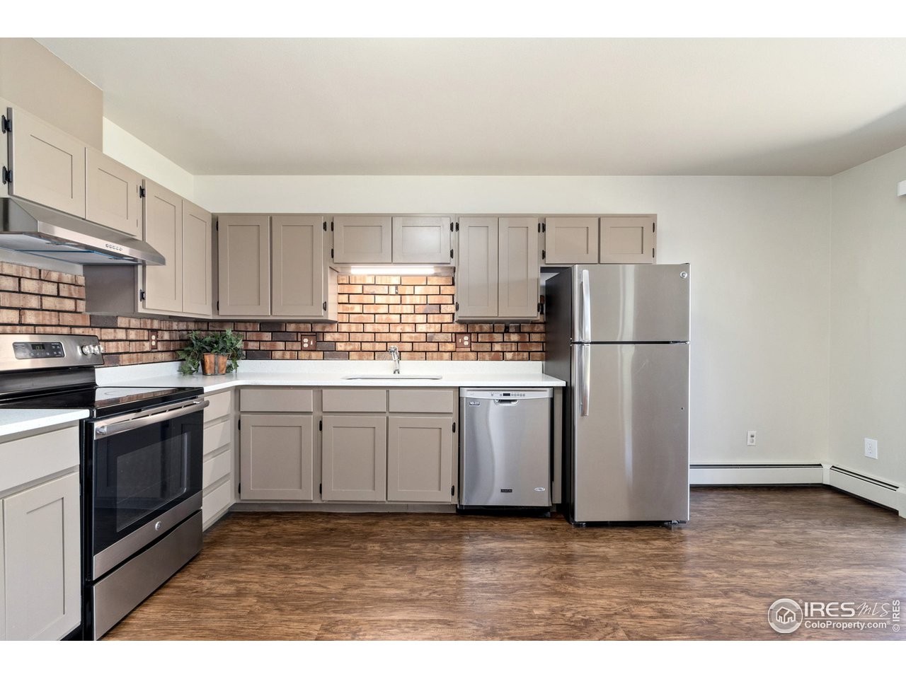 705 East Drake Road, Unit M 46 Fort Collins, CO 80525 - Photo 10 of 27 a kitchen with granite countertop a refrigerator stove top oven and sink
