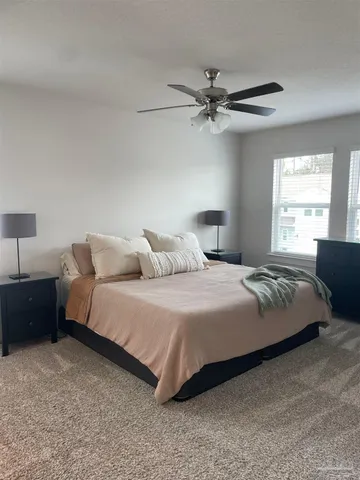 a bedroom with a bed and window