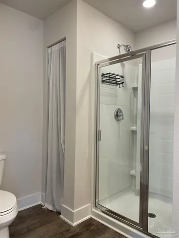 a bathroom with a shower and a toilet
