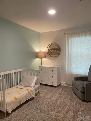 a bedroom with a bed and a couch