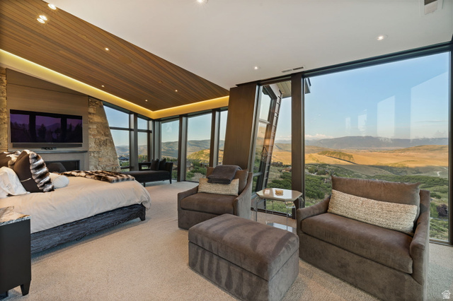 8544 North Promontory Ranch Road Park City, UT 84098 - Photo 15 of 36 Bedroom with a mountain view, floor to ceiling windows, carpet floors, recessed lighting, and a vaulted wood ceiling