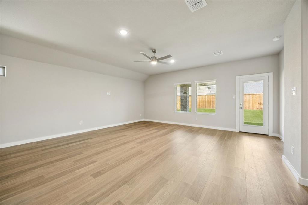 1195 Little Hls Way Lavon, TX 75166 - Photo 10 of 29 an empty room with wooden floor and windows