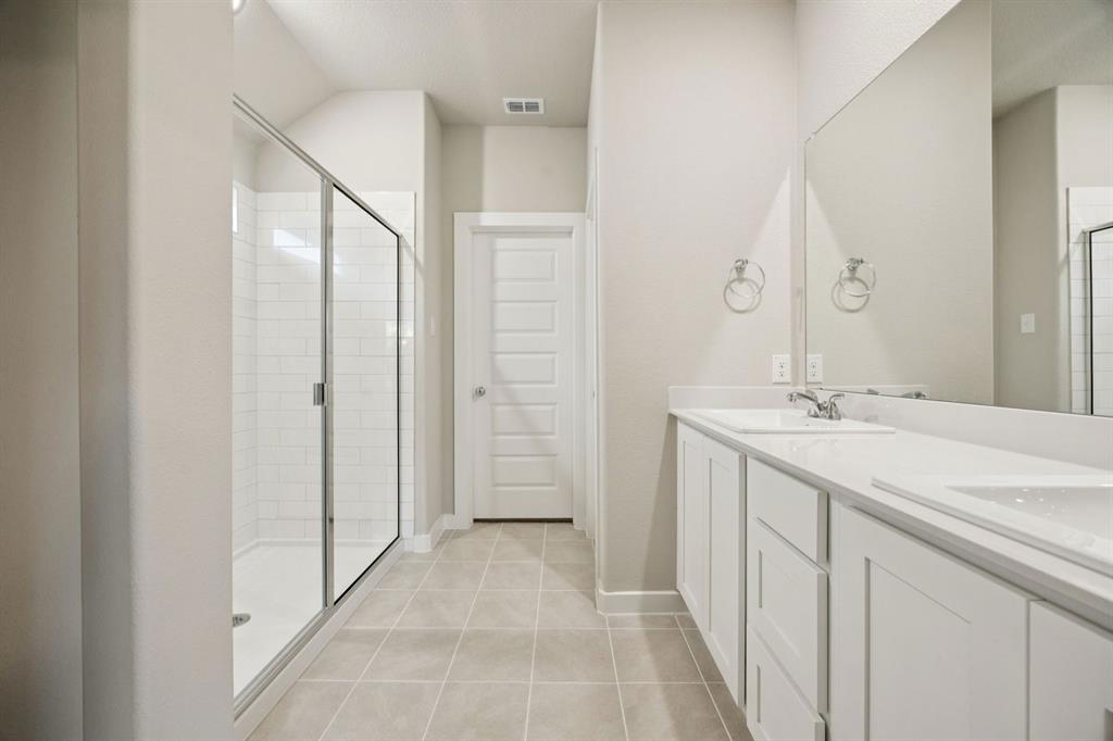 1195 Little Hls Way Lavon, TX 75166 - Photo 14 of 29 a bathroom with a double vanity sink and mirror