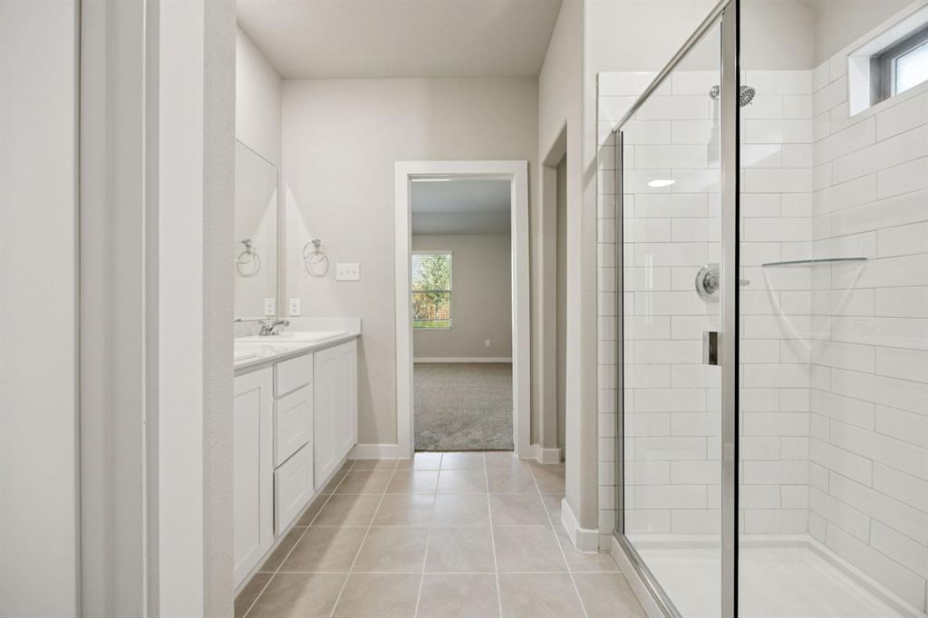 1195 Little Hls Way Lavon, TX 75166 - Photo 15 of 29 a bathroom with a double vanity sink and mirror