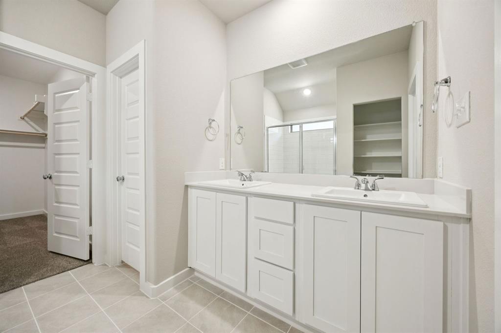 1195 Little Hls Way Lavon, TX 75166 - Photo 16 of 29 a bathroom with a double vanity sink and a mirror
