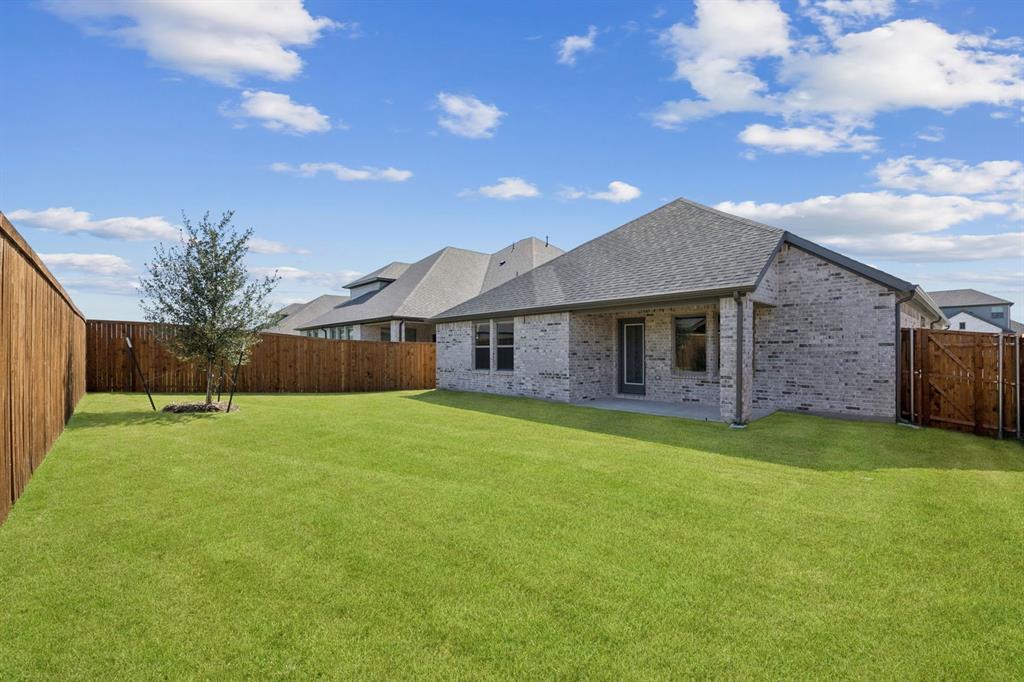 1195 Little Hls Way Lavon, TX 75166 - Photo 26 of 29 a backyard of a house with plants and wooden fence