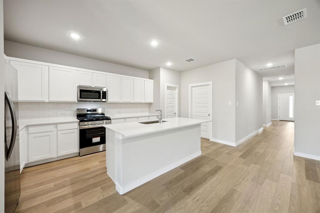 1195 Little Hls Way Lavon, TX 75166 - Photo 7 of 29 a kitchen with a refrigerator stove top oven and sink
