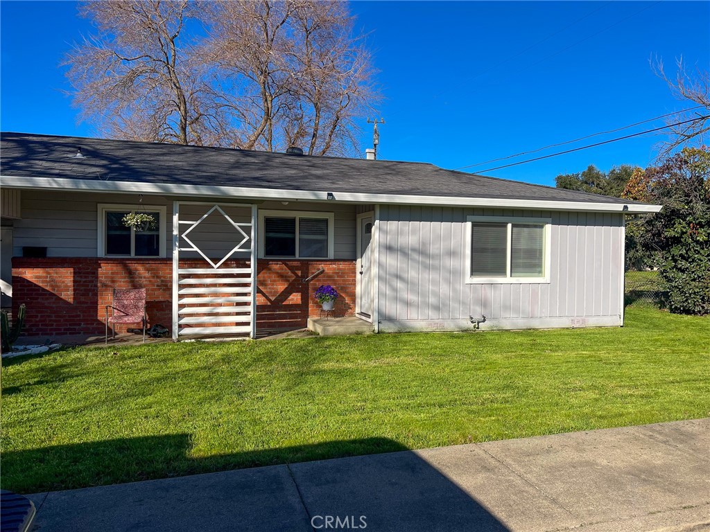 a backyard of a house with table and chairs