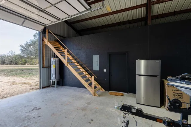 a kitchen with a refrigerator and a wooden floor
