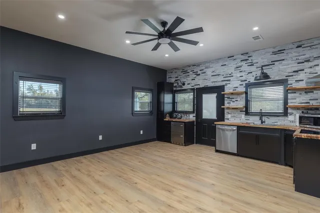 an empty room with closet and a ceiling fan