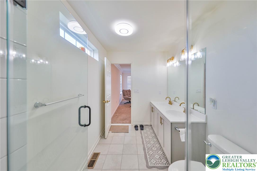 1105 Meco Road Easton, PA 18040 - Photo 54 of 100 Clean tile flooring and a double vanity define this bright bathroom space.