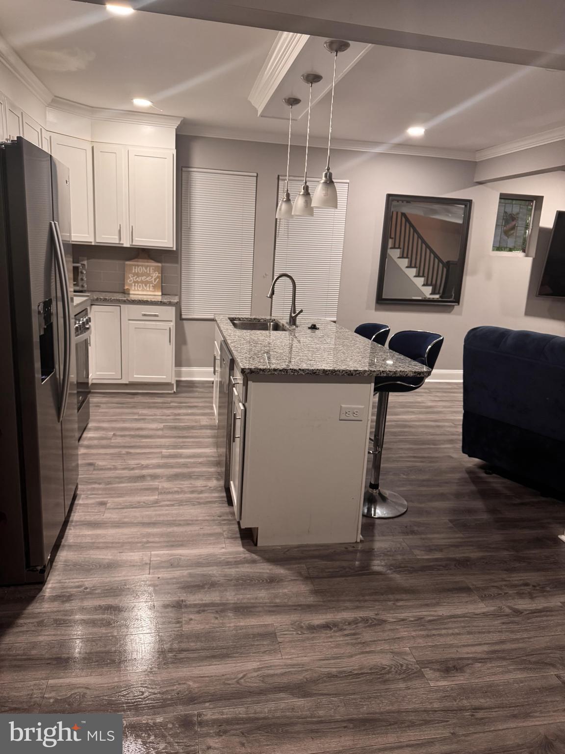 a kitchen with stainless steel appliances granite countertop a sink a stove and refrigerator