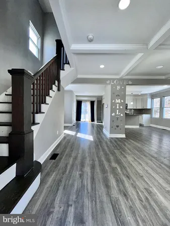 a view of entryway and hall with wooden floor