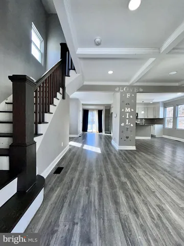 a view of entryway and hall with wooden floor