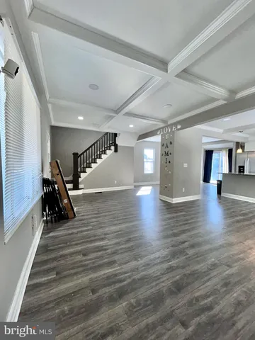 a view of a room with wooden floor