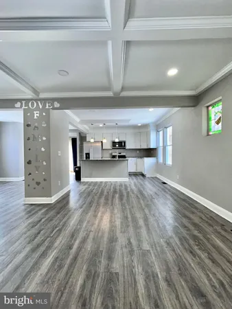a view of a room with wooden floor