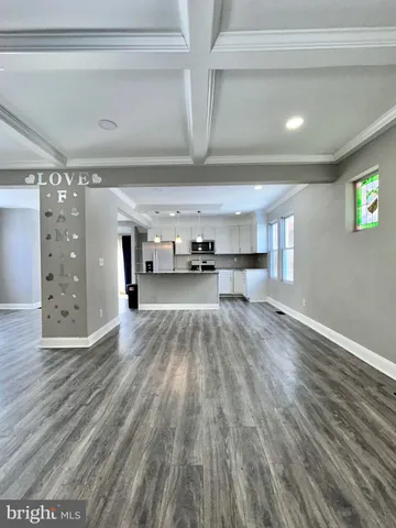 a view of a room with wooden floor