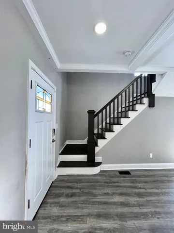 a view of entryway and hall with wooden floor
