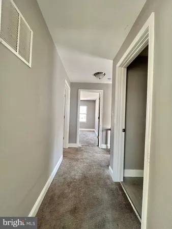 a view of a hallway with wooden shelves