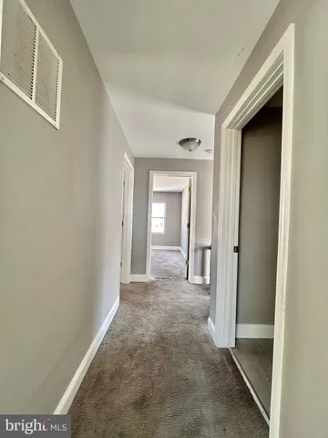 a view of a hallway with wooden shelves