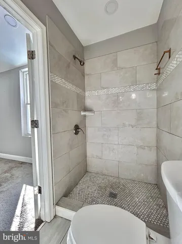 a bathroom with a toilet and a shower