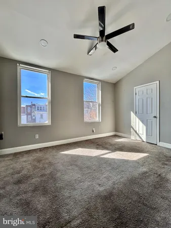 a view of a livingroom with a ceiling fan and window