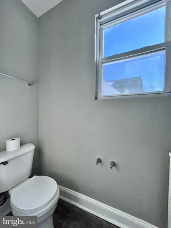 a white toilet sitting next to a shower