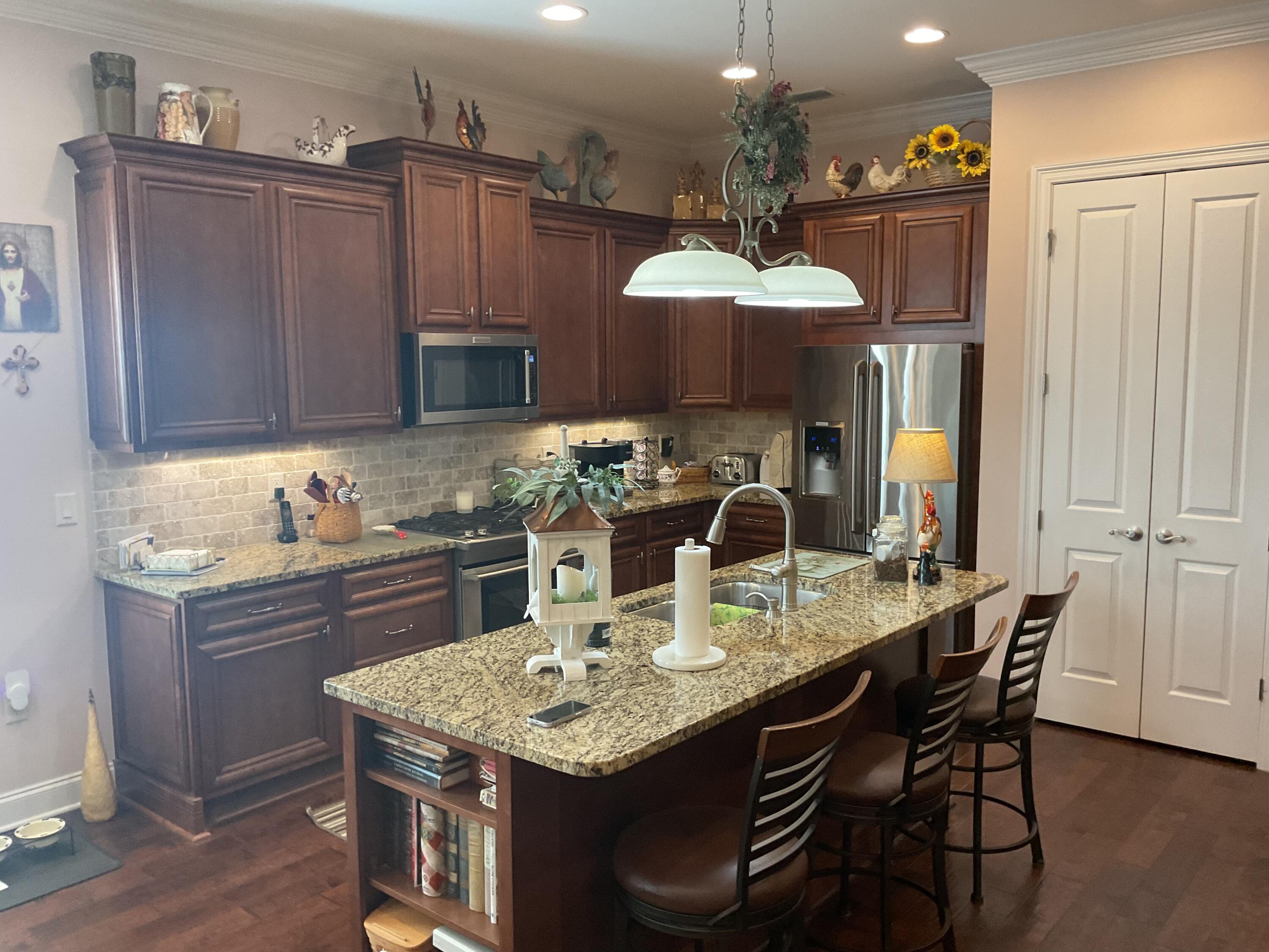 55 Derby Downs Circle Niceville, FL 32578 - Photo 18 of 34 a kitchen with a table chairs and white cabinets