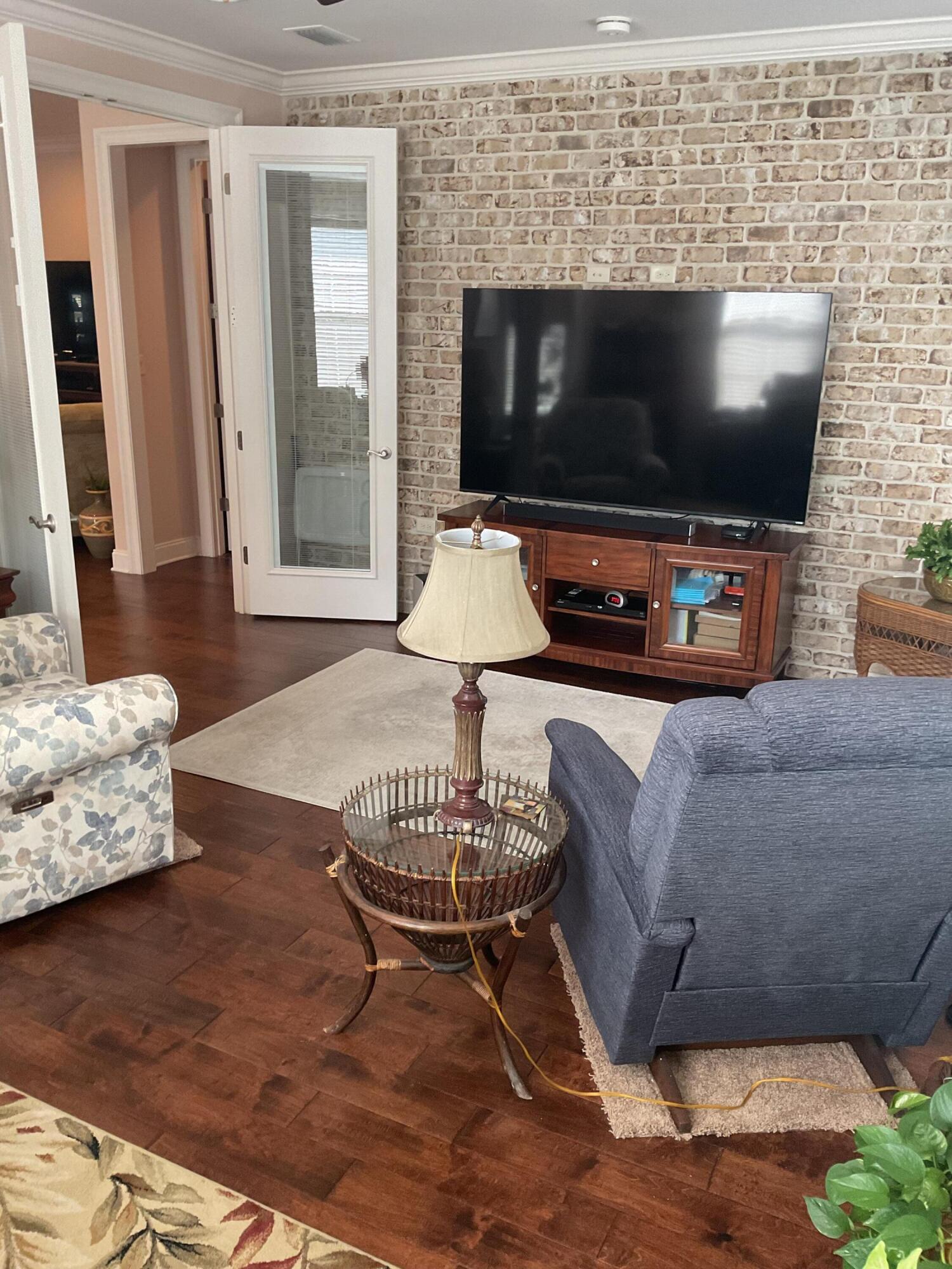 55 Derby Downs Circle Niceville, FL 32578 - Photo 22 of 34 a living room with furniture and a flat screen tv