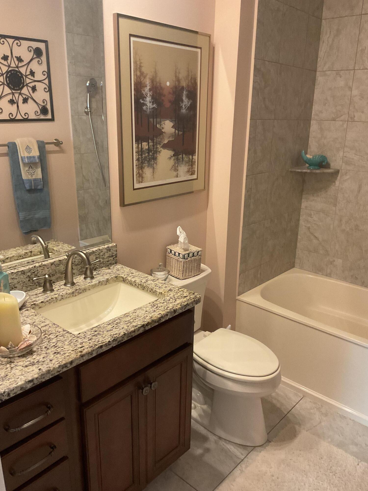 55 Derby Downs Circle Niceville, FL 32578 - Photo 25 of 34 a bathroom with a granite countertop toilet a sink and a bath tub