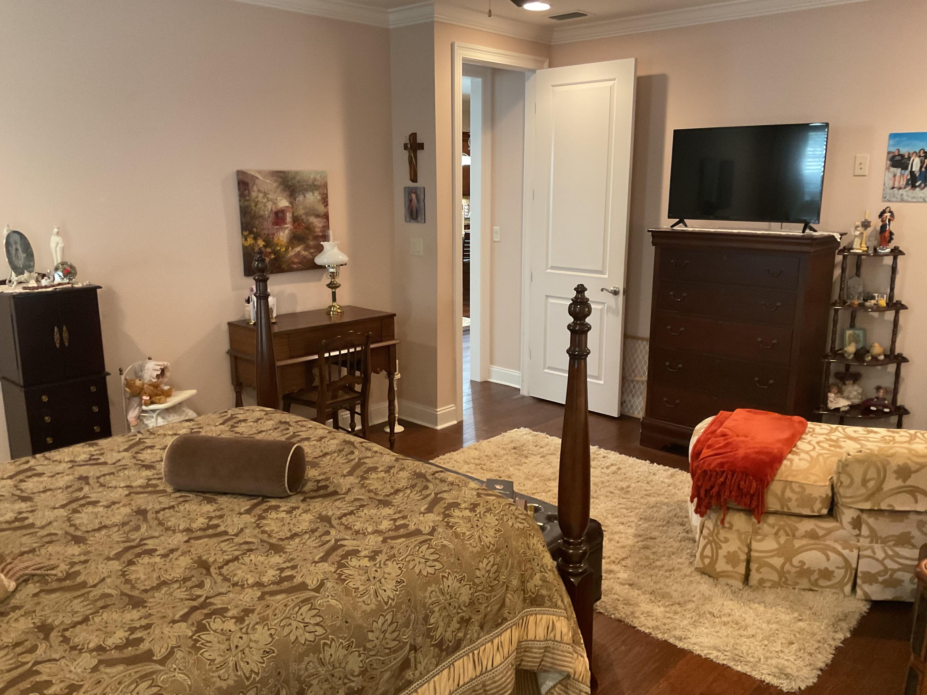 55 Derby Downs Circle Niceville, FL 32578 - Photo 30 of 34 a bedroom with a bed and a flat screen tv