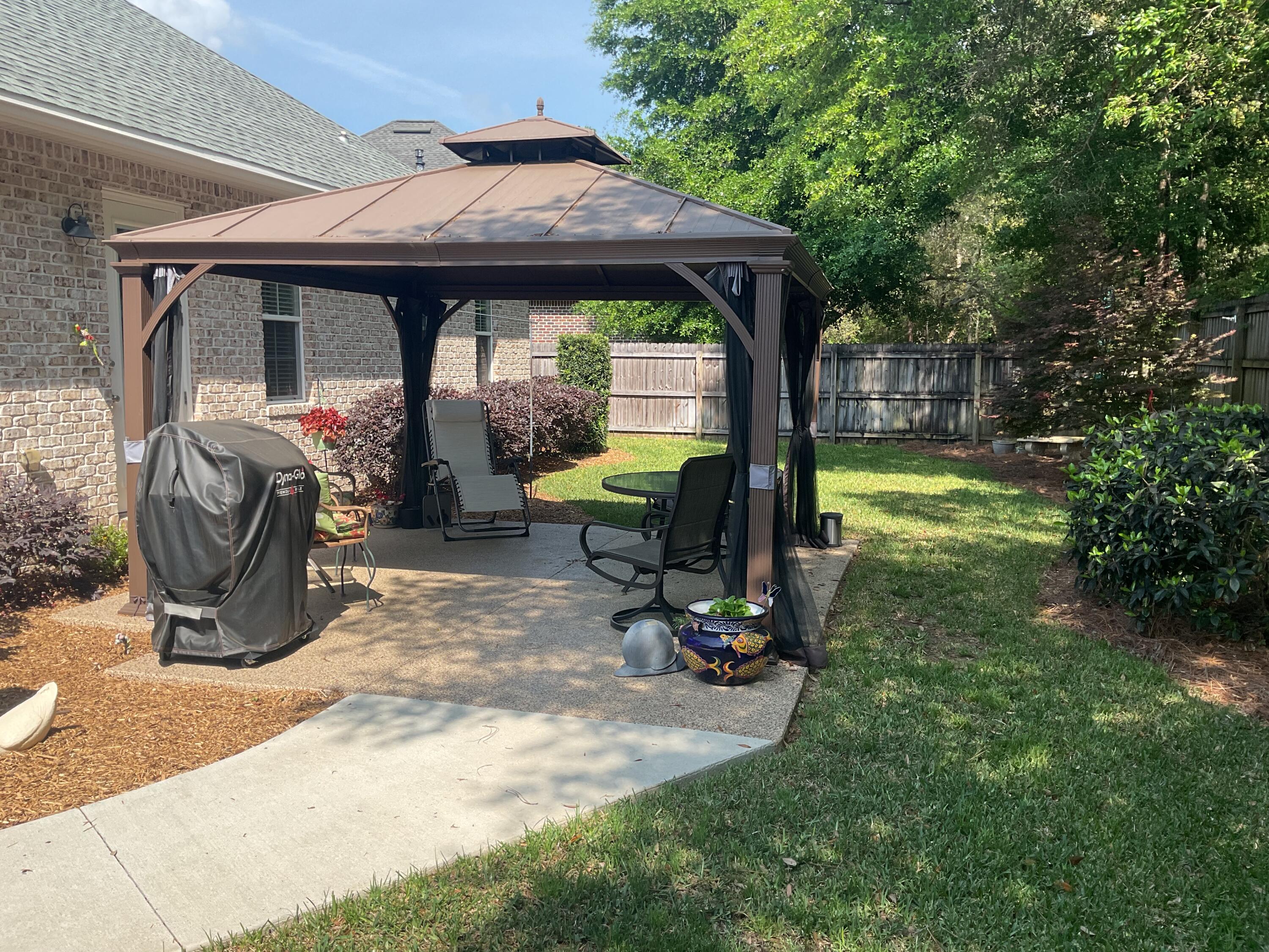 55 Derby Downs Circle Niceville, FL 32578 - Photo 6 of 34 a view of a chair and table in backyard of the house