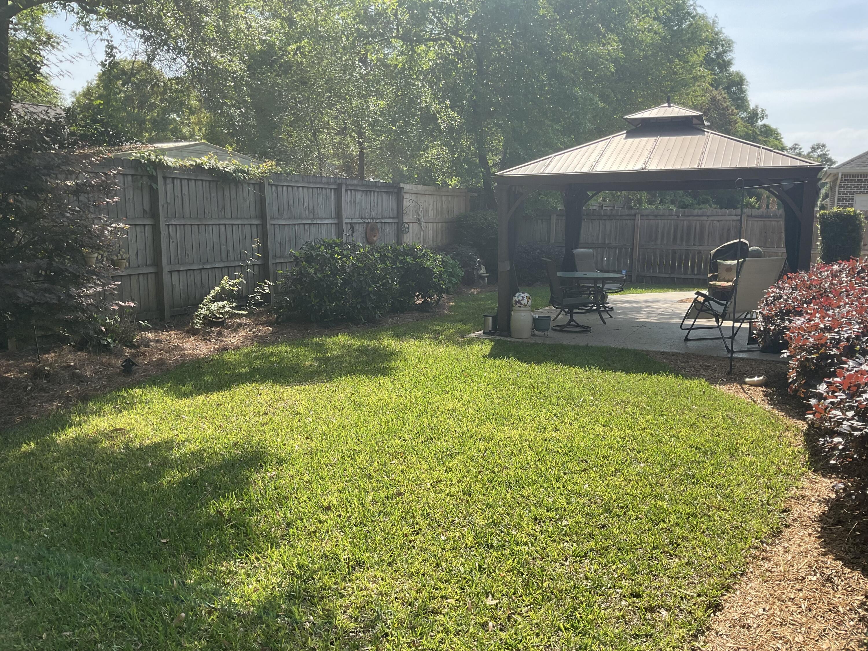 55 Derby Downs Circle Niceville, FL 32578 - Photo 9 of 34 a view of a backyard with plants and patio