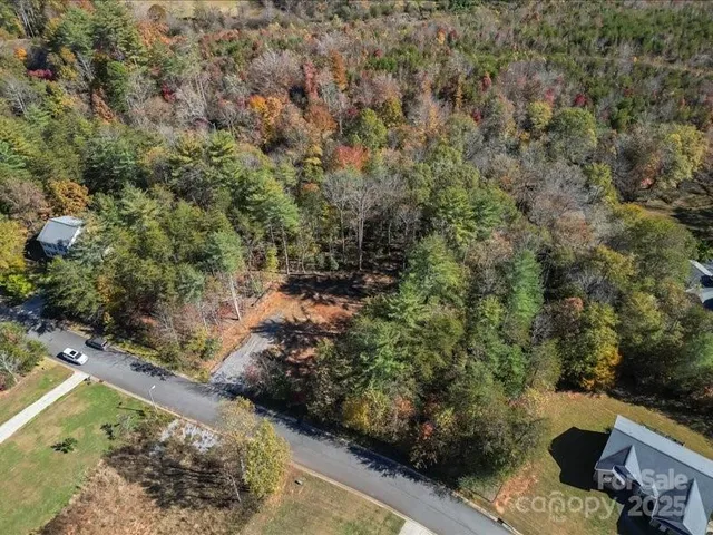 a view of a yard with wooden fence