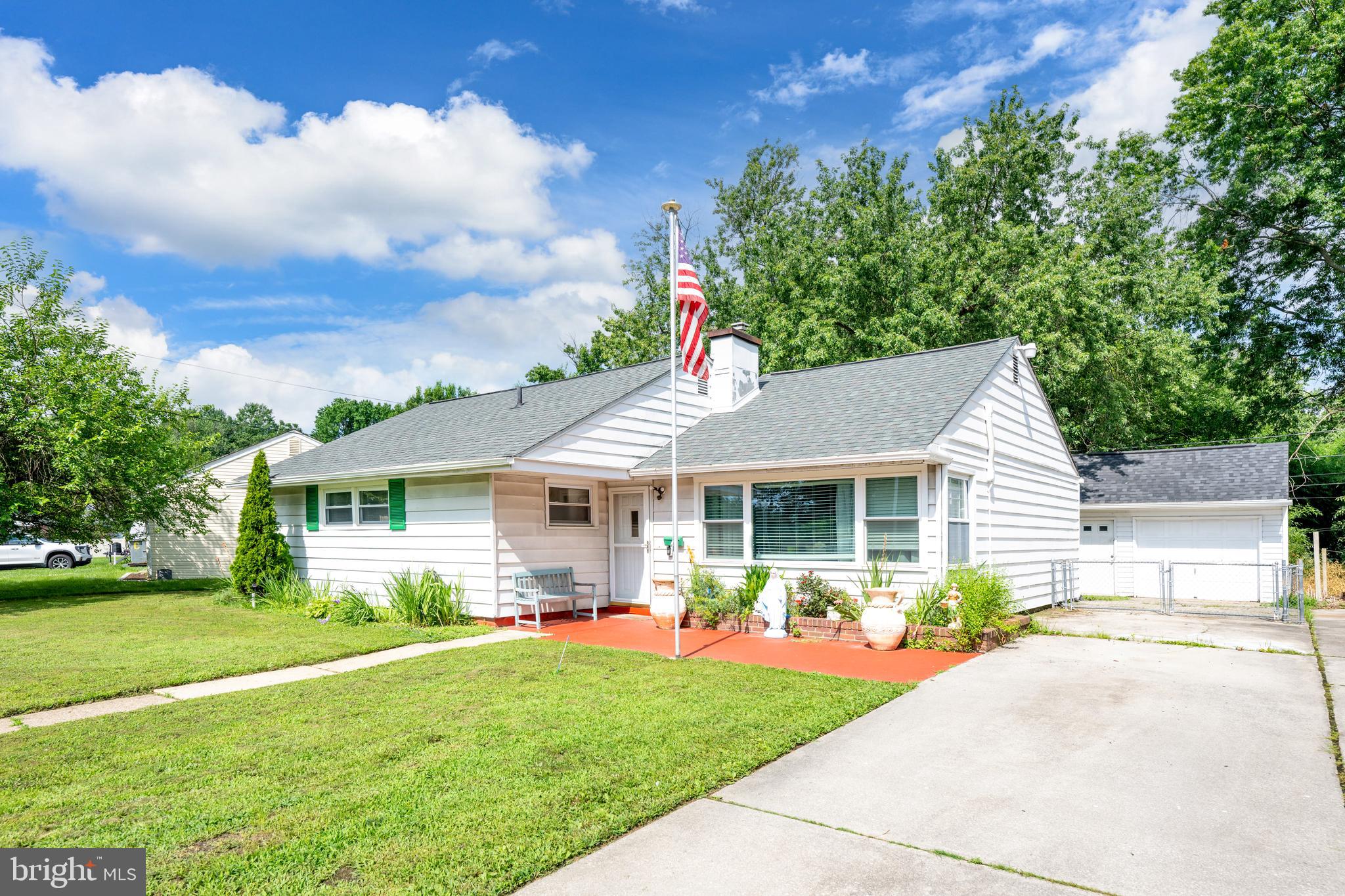 7 Gainor Road New Castle, DE 19720 - Photo 1 of 26 a front view of a house with a garden and yard