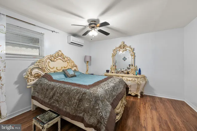 a bed sitting in a bedroom next to a window and a chandelier