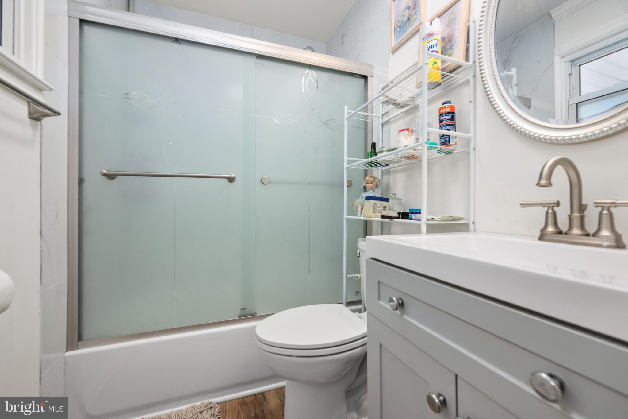 7 Gainor Road New Castle, DE 19720 - Photo 13 of 26 a bathroom with a sink a toilet and a mirror