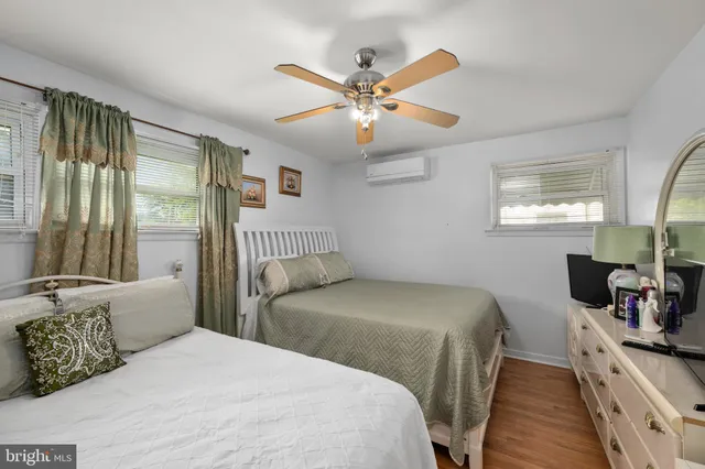 a bedroom with a bed and a large mirror with a flat tv screen