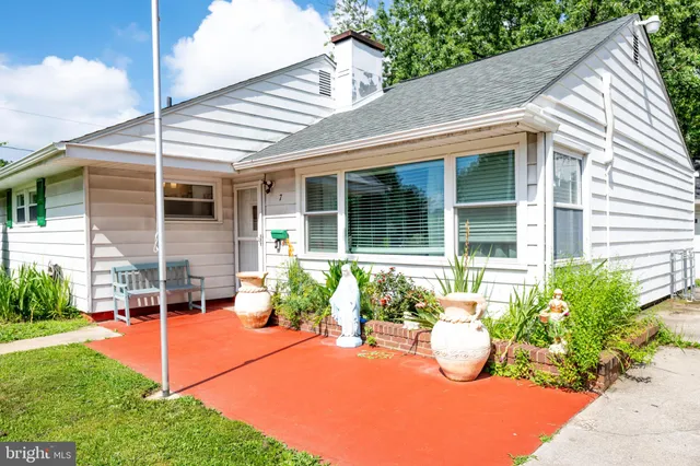 a view of a house with sitting area and garden